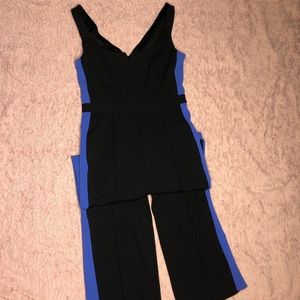 Classy black jumpsuit with blue side stripe.